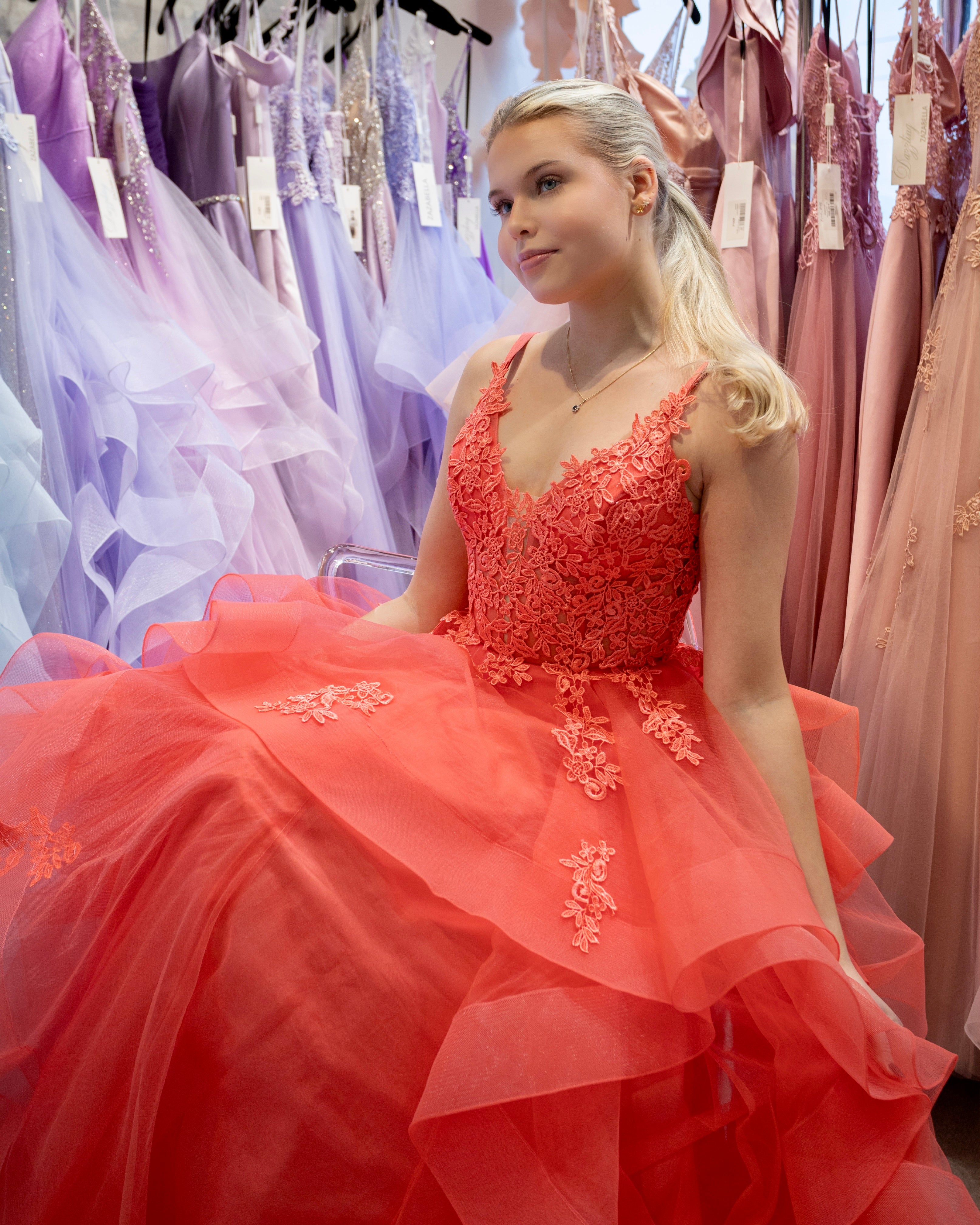 Oranssi vanhojentanssimekko pitsiyläosalla ja röyhelöhelmalla, etu.