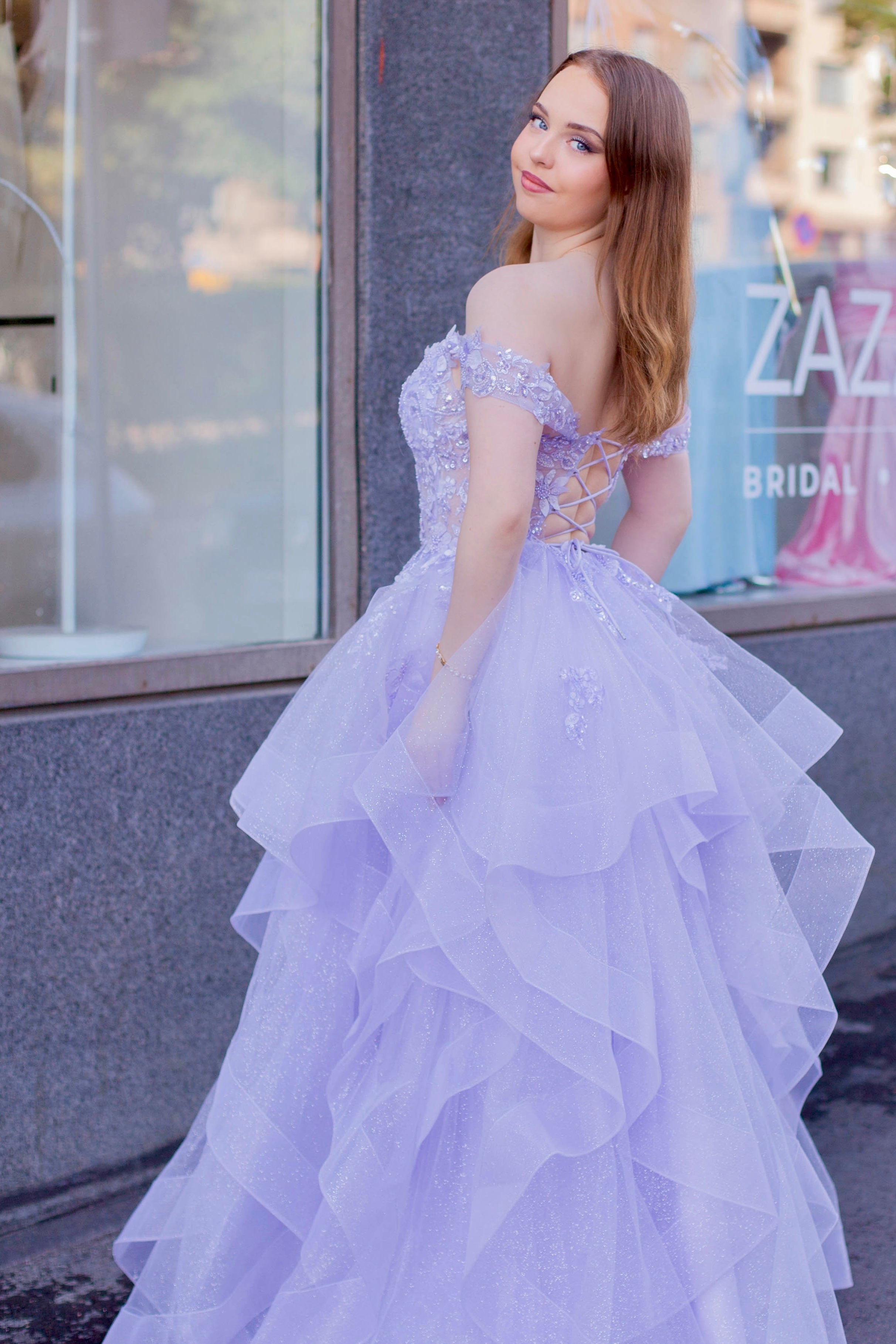 Violetti kimaltava vanhojentanssimekko off shoulder -yläosalla ja röyhelöhelmalla.