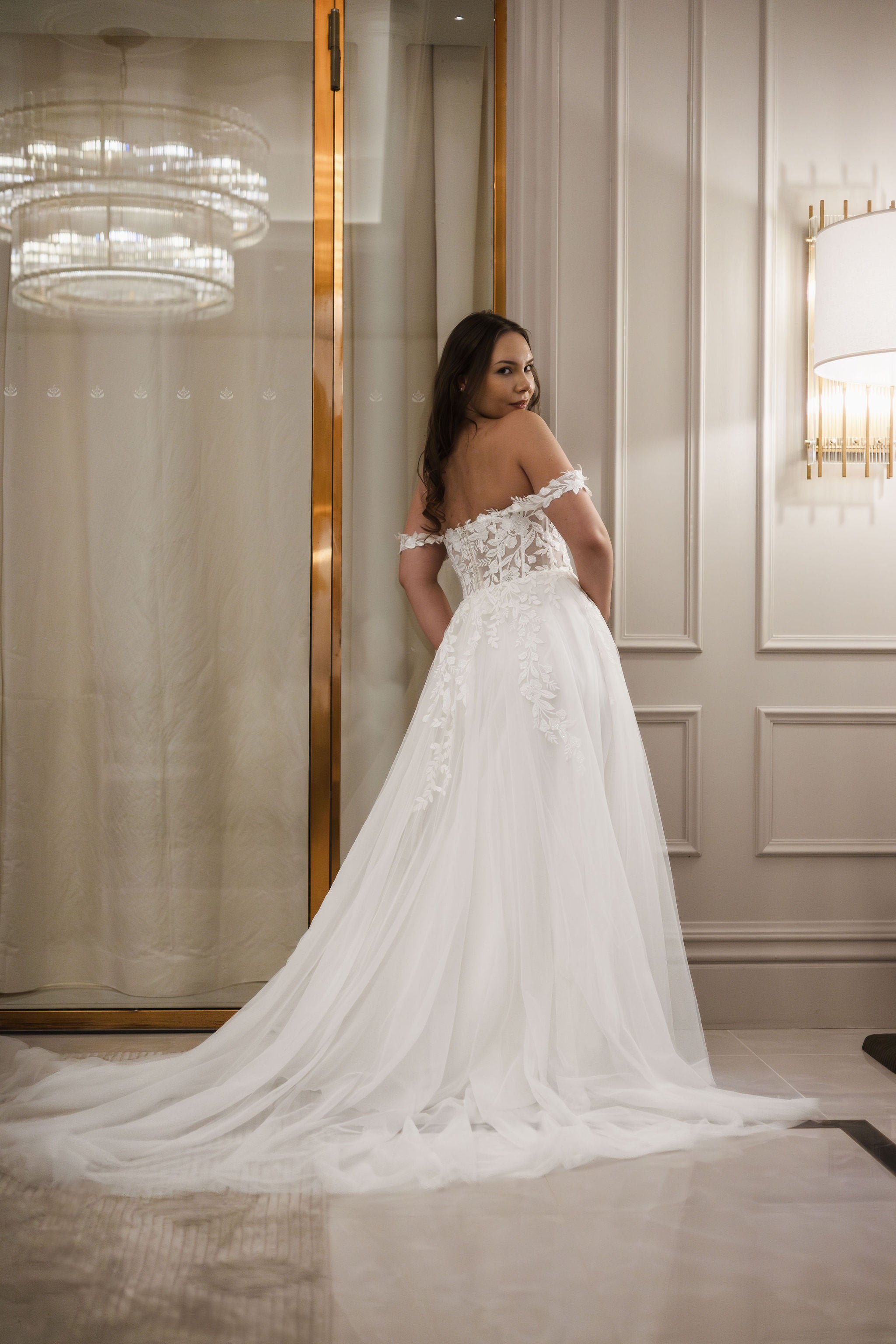 Häämekko pitsiyläosalla, läpikuultava selkä ja näyttävä tyllilaahus, takaa.