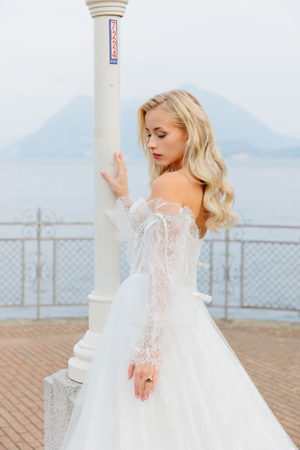 Häämekko korsettimaisella yläosalla ja pitsisillä hihoill, takaa.