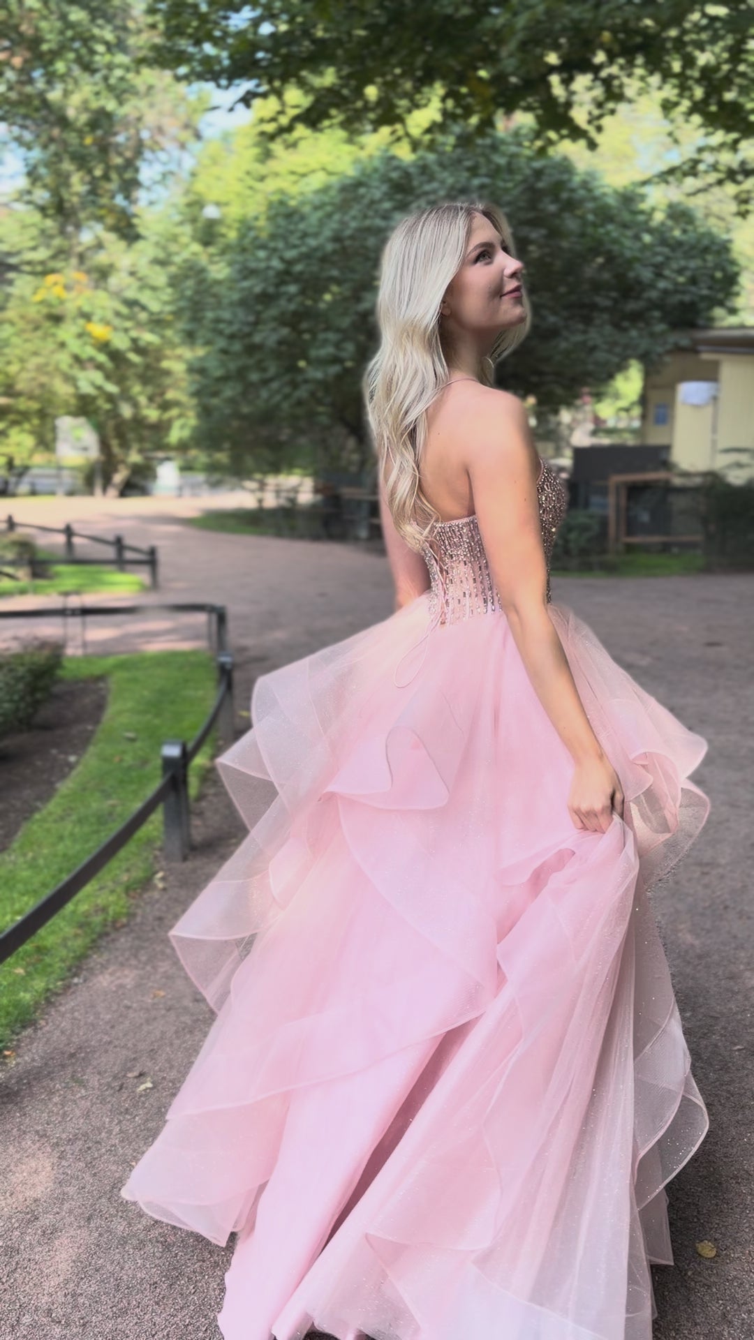 Dustypink vanhojentanssimekko kirjailulla koristellulla yläosalla ja röyhelöhelmalla, video.